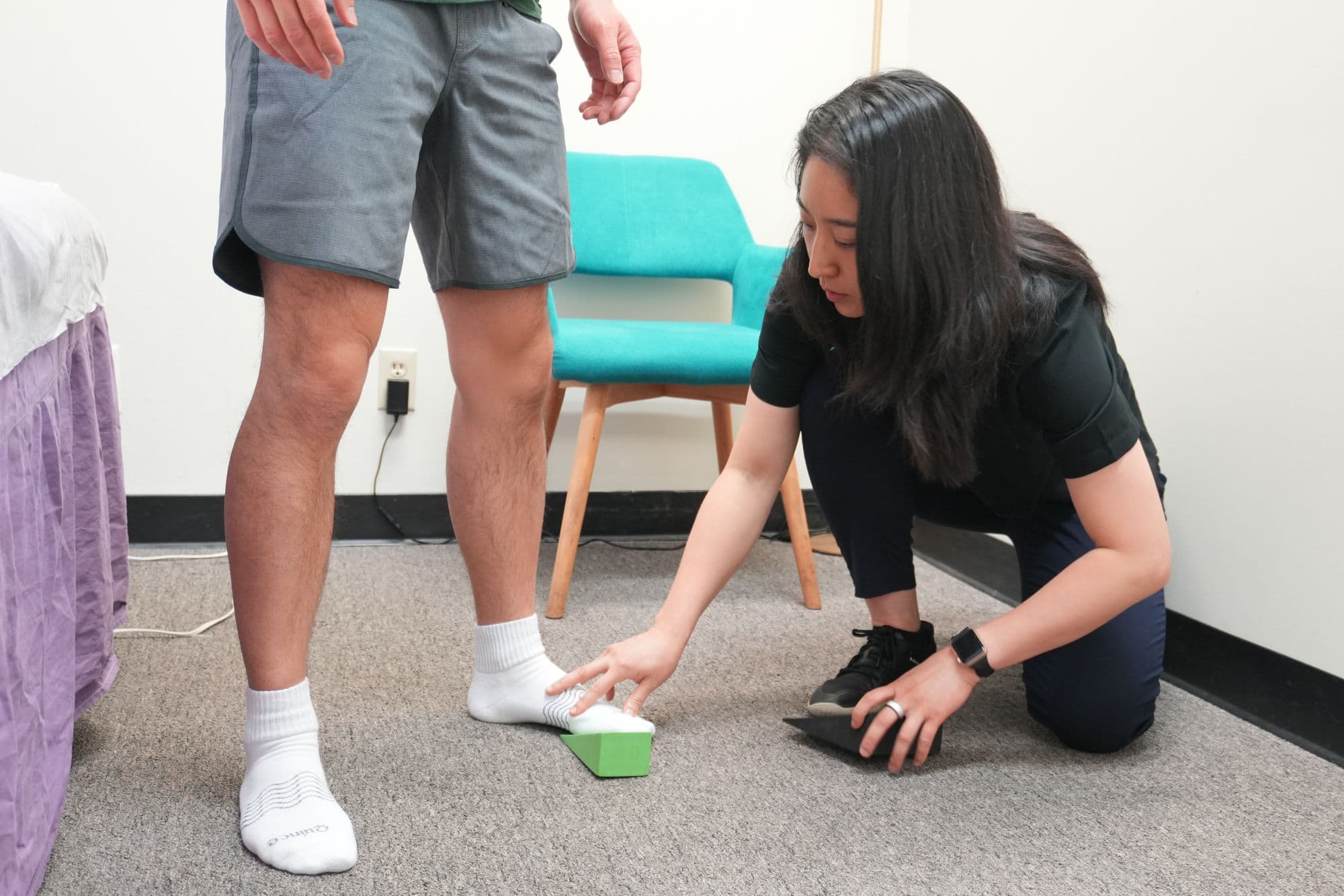 Haidee guiding a patient through a balance exercise